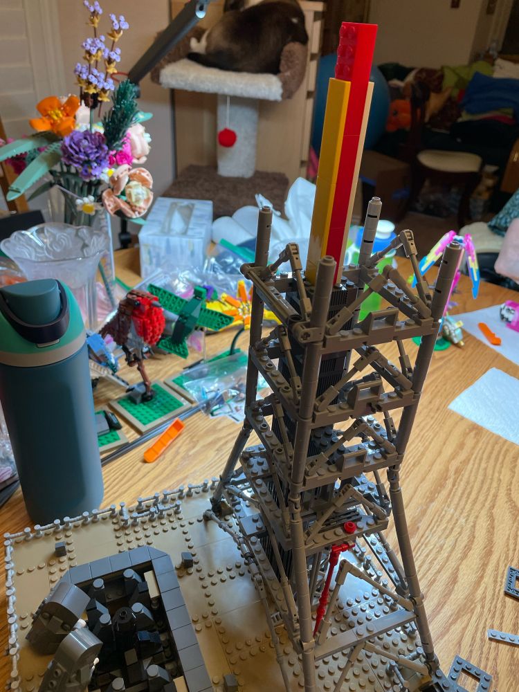 Artemis Lego build in progress featuring the scaffolding on a cluttered oak dining table