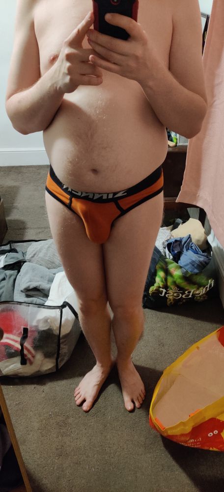 Naked except for a pair of lingerie underwear. 
Erect cock outline visible