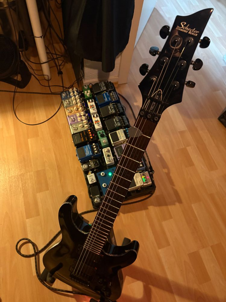 Picture of my Schecter guitar and my Main Pedalboard