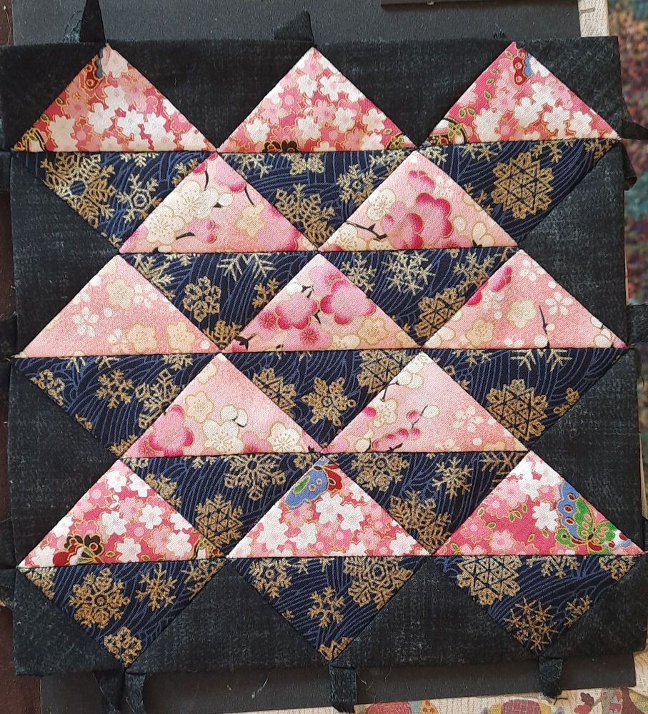 A block of patchwork, rows of pink and navy, Asian influenced fabrics.  