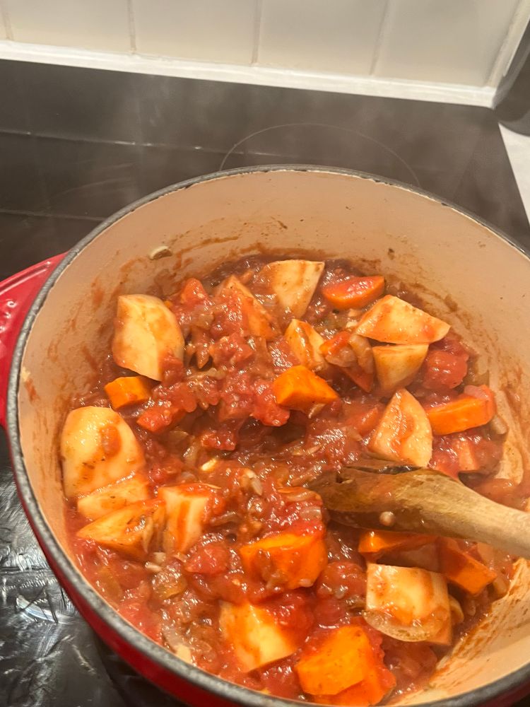 Tomato’s stirred into the pan with the potatoes and carrots. 