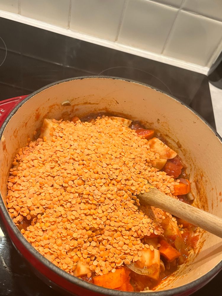 Lentils in the pit on top of the potato, carrots and tomato. 