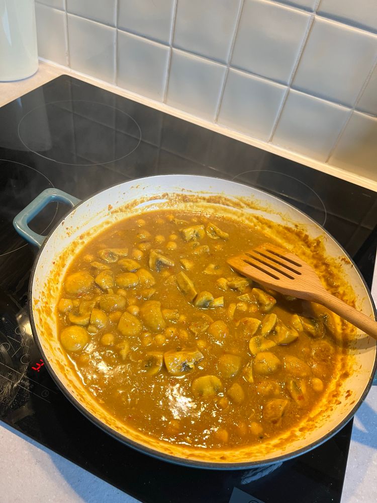 A pan of mushroom curry on the hob. 