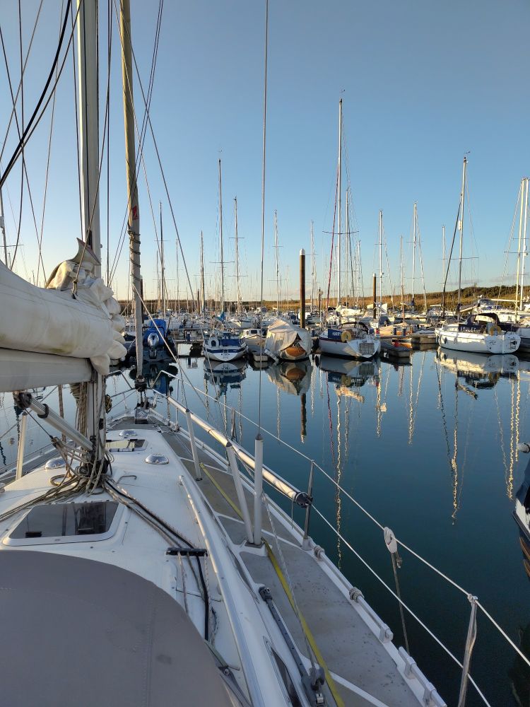 View from the deck of my boat looking out over titchmarsh marina on a cold blue day.