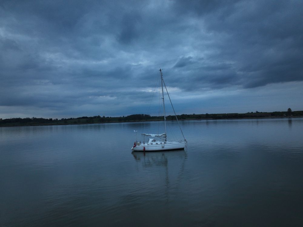Side on shot of a yacht taken from a drone in the River Stour