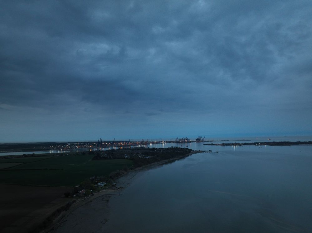 Felixstowe docks from the distance late in the evening under moody skies.