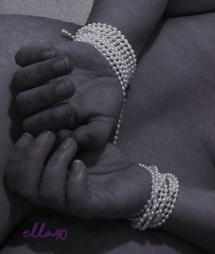 Woman hands tied in the back with pearls