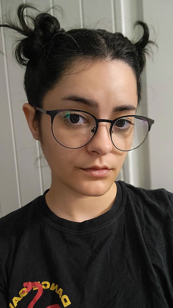 me wearing glasses with my hair in two buns