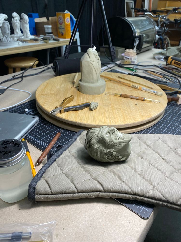 Joker bust with the head separated from the body in preparation for molding and casting. Head in the foreground.