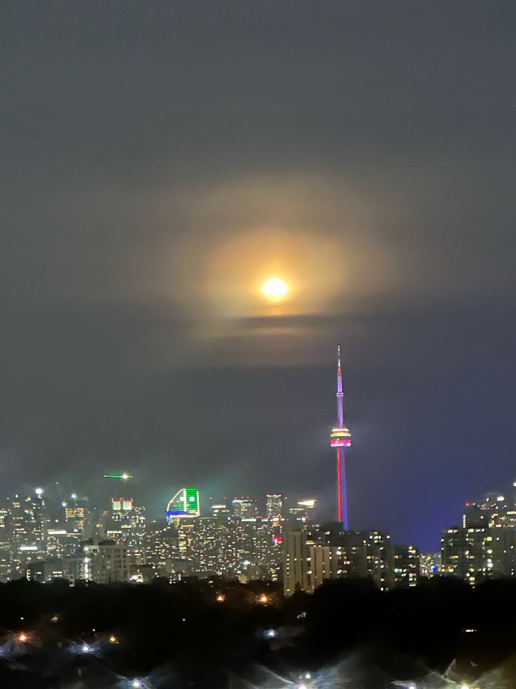 Full moon above CN Tower Toronto. 
