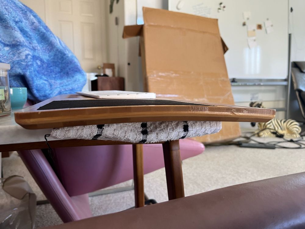 side profile of a bamboo lap desk. it’s warped 