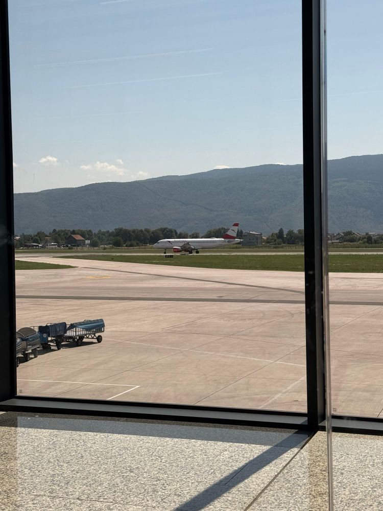 photo of Sarajevo airport looking at the runway with an Austrian airlines plane having just landed