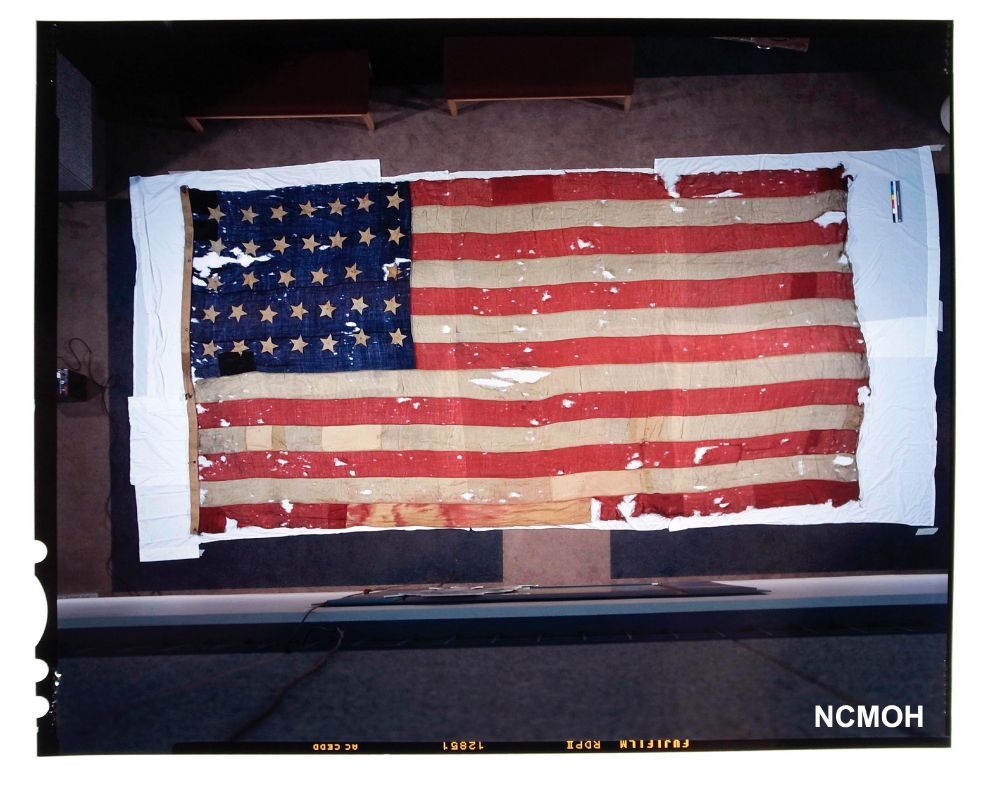 4x5vFuji Provia 100 color transparency of a 26 foot long American flag, photographed from above. A detail was shot later of stenciling along edge that read "Presented to T.W. Davidson by the citizens of New Bern, NC March 14, 1863". (NCMOH 1996.177.1)