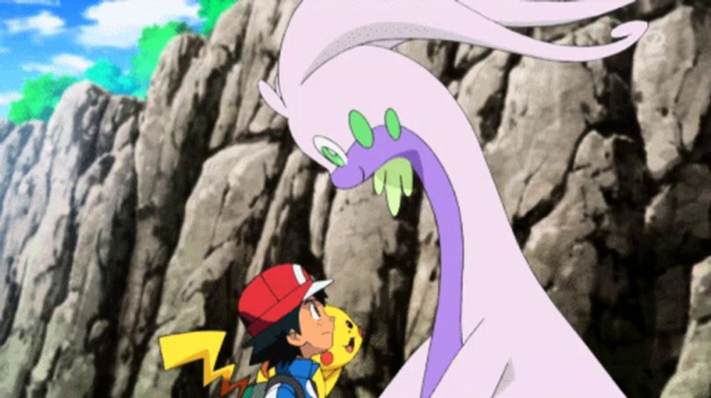 a boy in a red hat stands next to a pikachu and a purple dragon