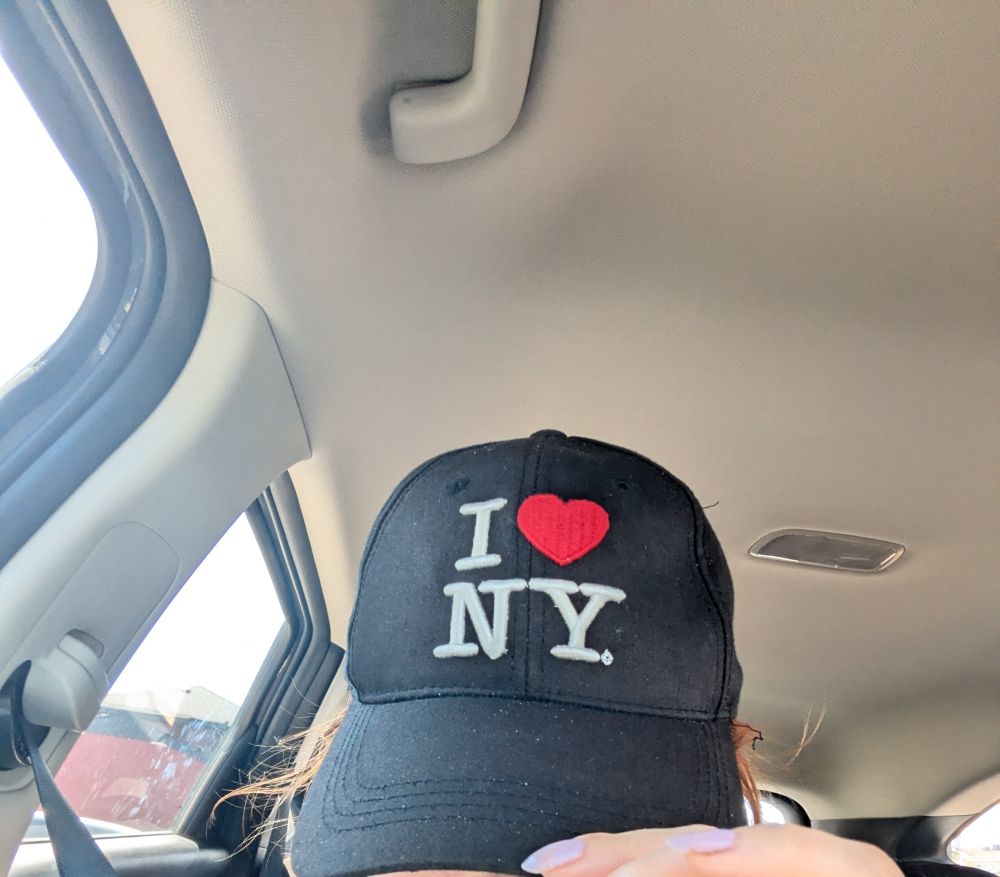 me in an I HEART NY hat