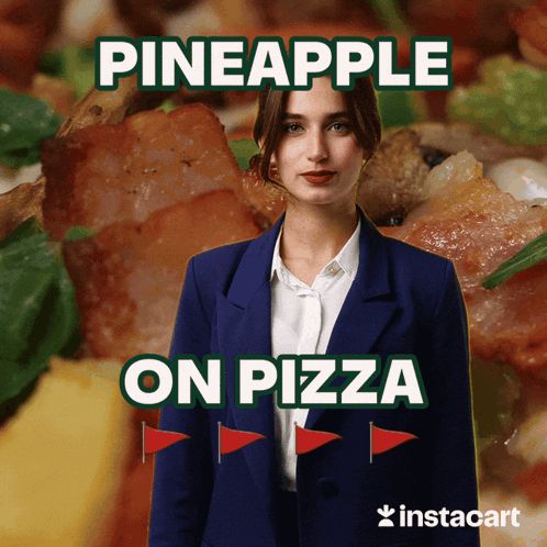 a woman in a suit is standing in front of a pizza with pineapple on pizza