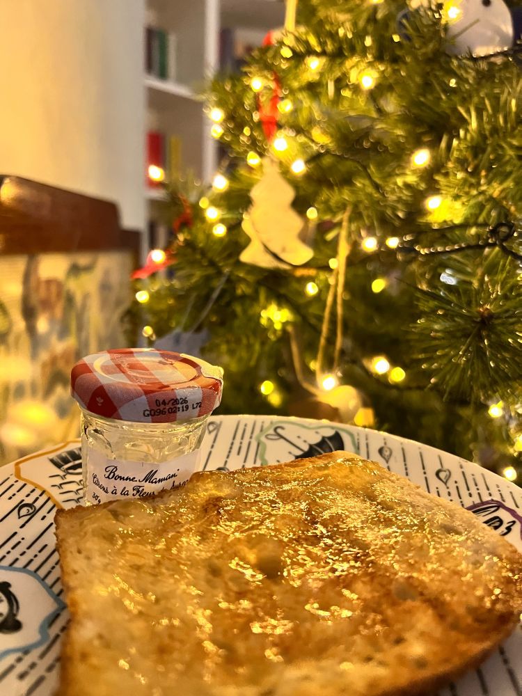 Lemon with Elderflower jam on toast - with a Christmas tree behind with a Bonne Maman decoration on it 