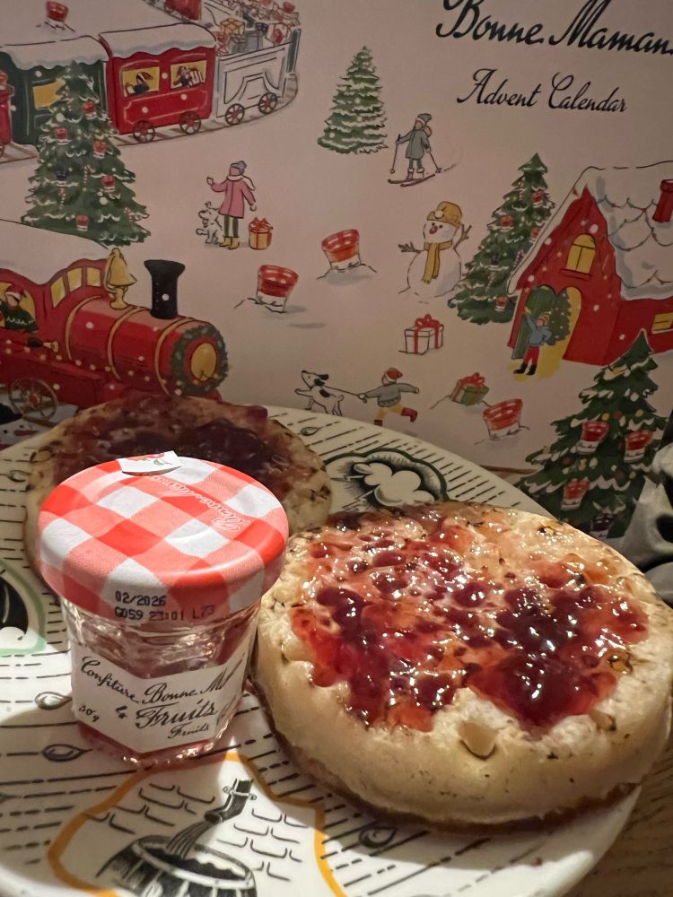 A mini jar of Four Fruits jam, with crumpets 