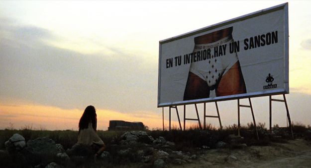 Penelope Cruz collapses in front of a roadside billboard featuring Javier Bardem’s bulge