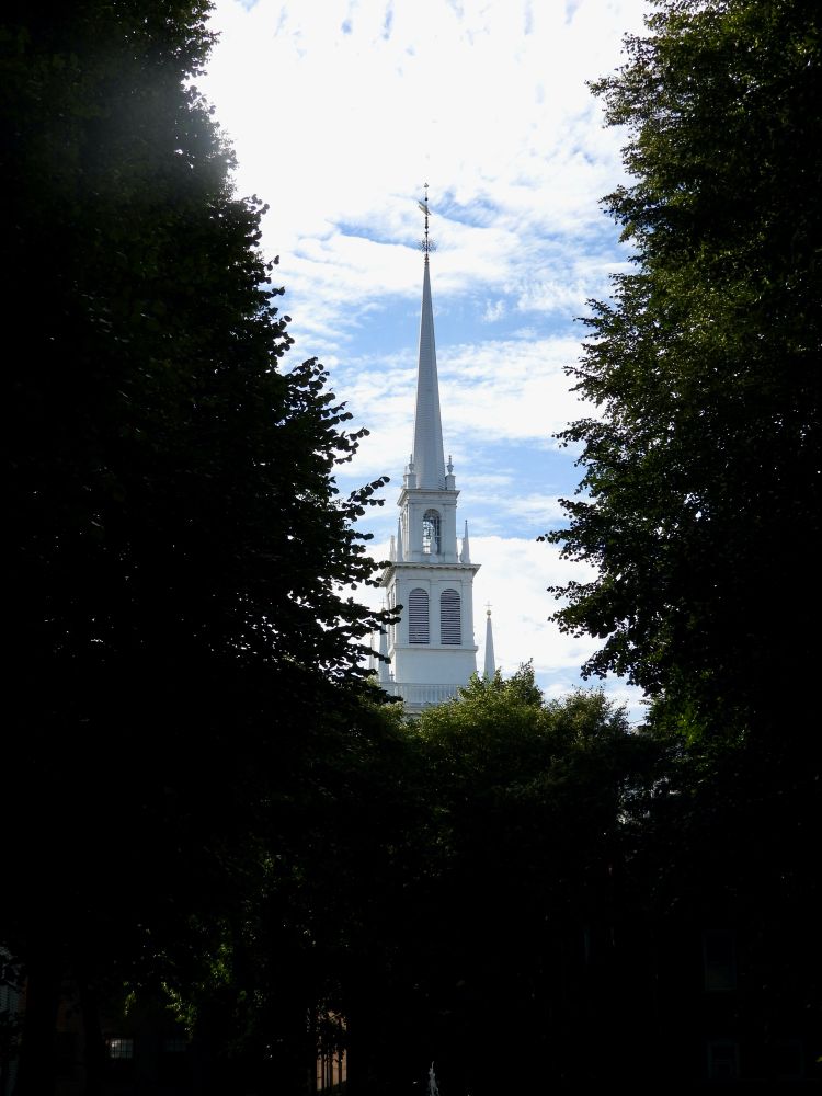 The steeple of the Old North Church in Boston peeks above the trees