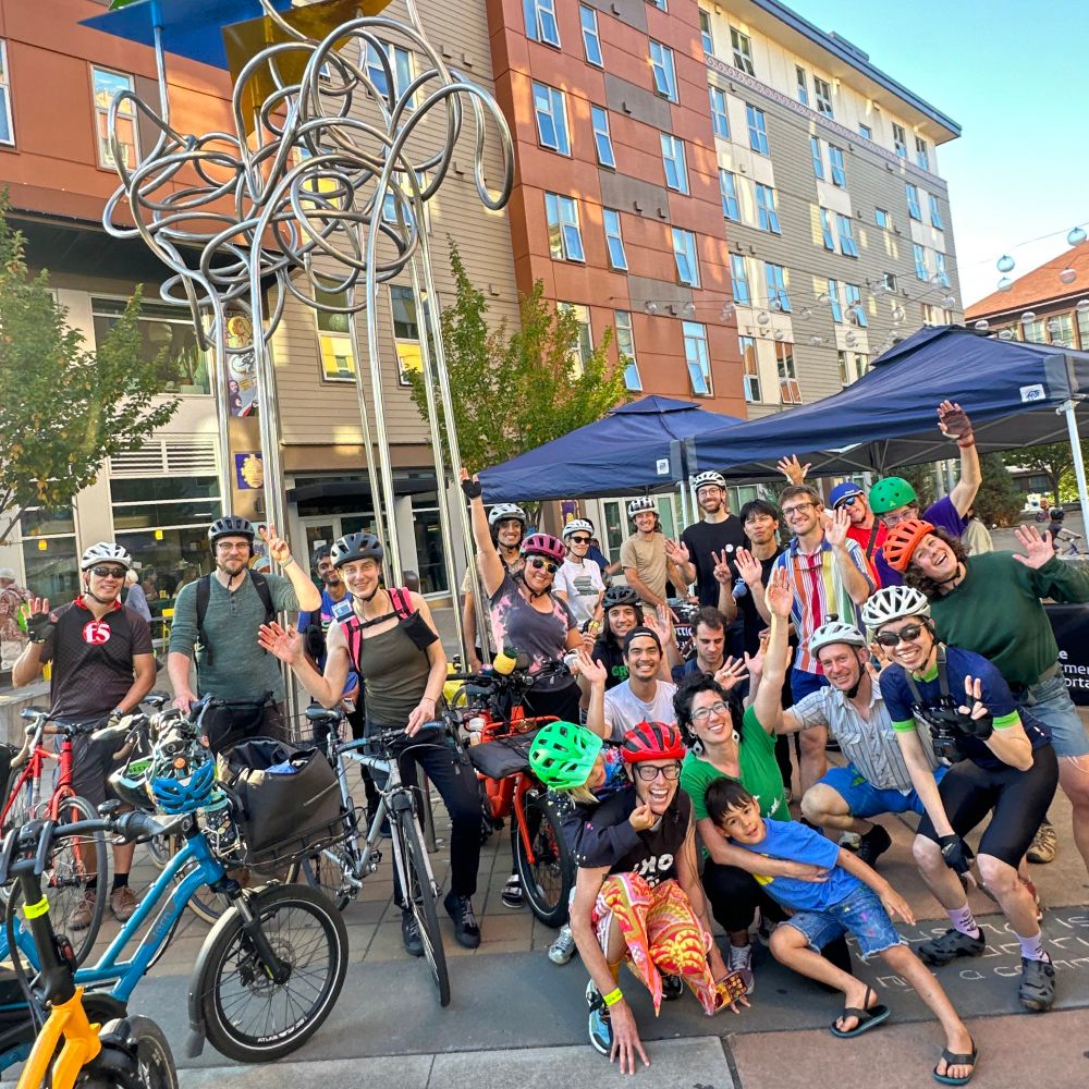 Group of community members and advocates outside of El Centro Del Raza, celebrating the new Beacon Hill bike lanes.