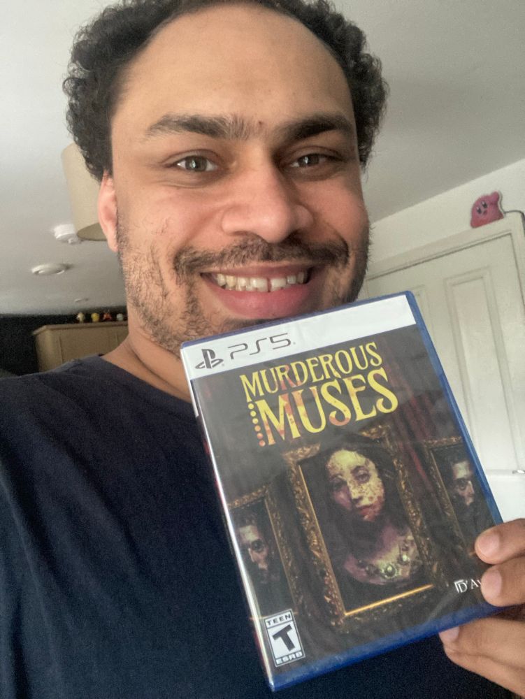 Me holding my copy of Murderous Muses for the PS5!
