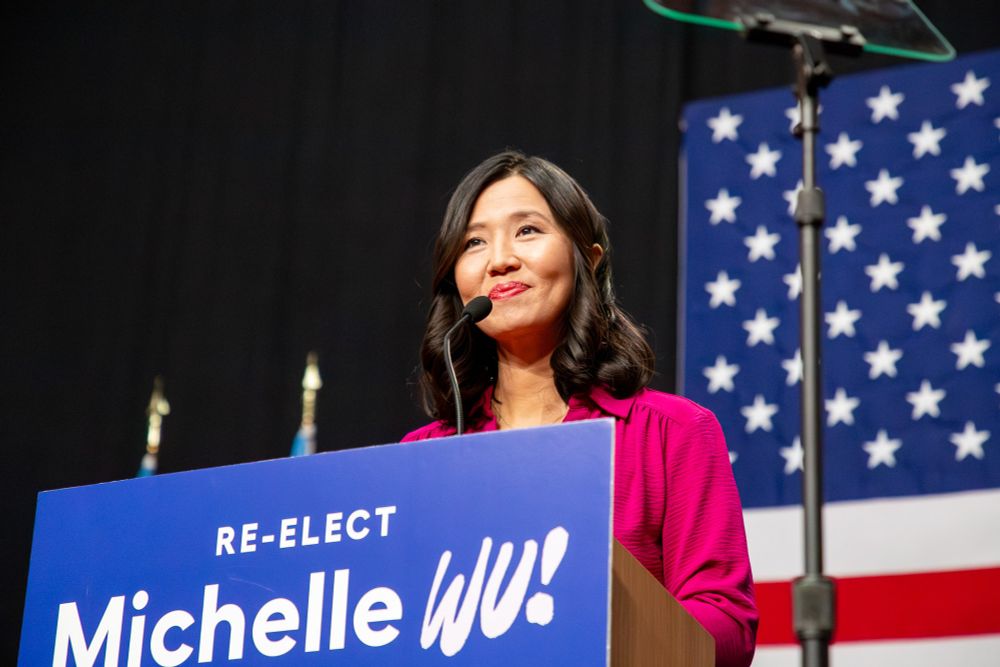Portrait of Mayor Michelle Wu standing at a podium.