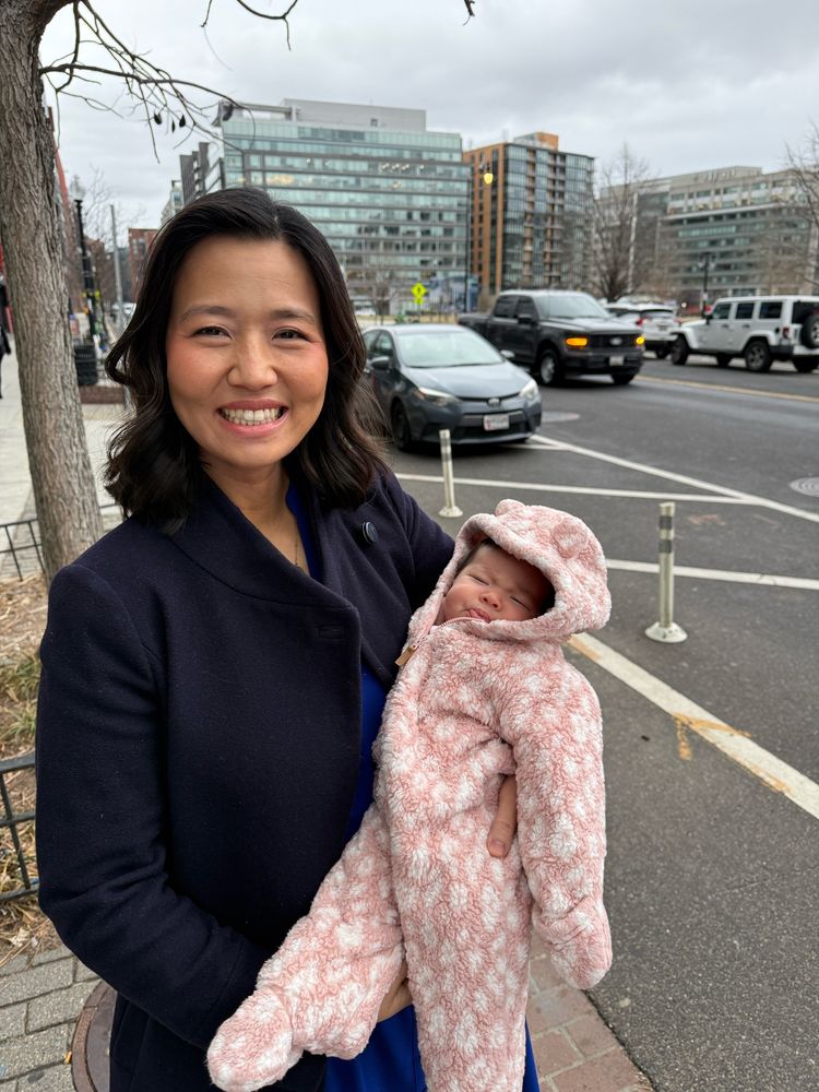 Michelle holds Mira on a sidewalk in Washington DC as they get ready to leave the hotel 
