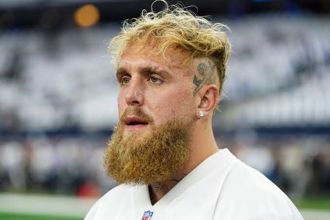 Jake Paul in a sports stadium with a weird-ass beard.