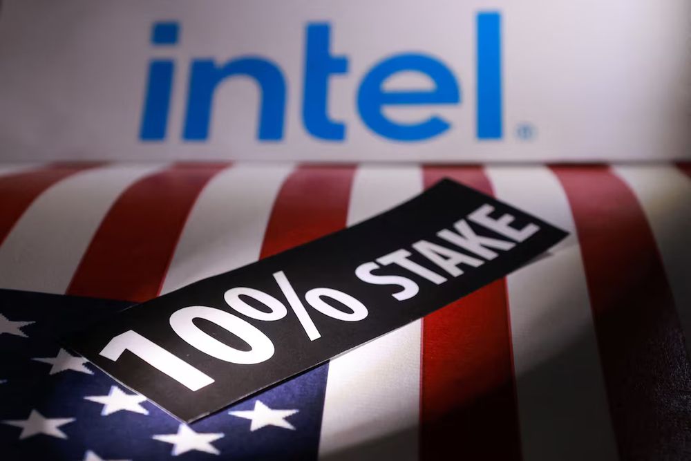 Image of the Intel logo overlooking an American flag, with a black bumper sticker across it reading in white letters 