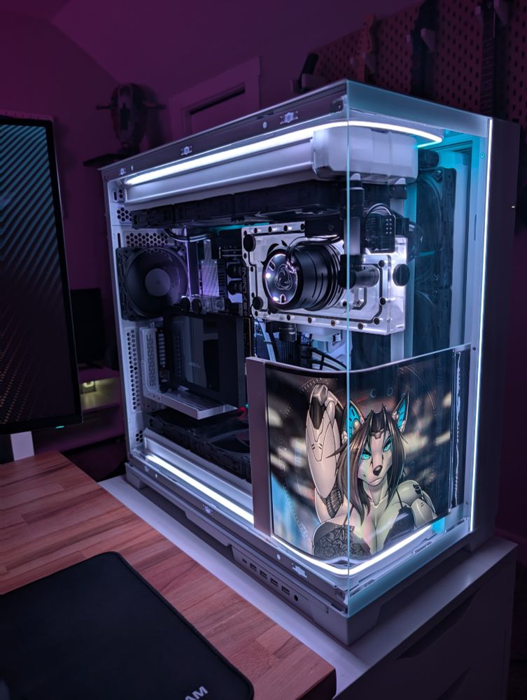 Close up of the gaming PC with an anthro cyborg fox on the internal curved display