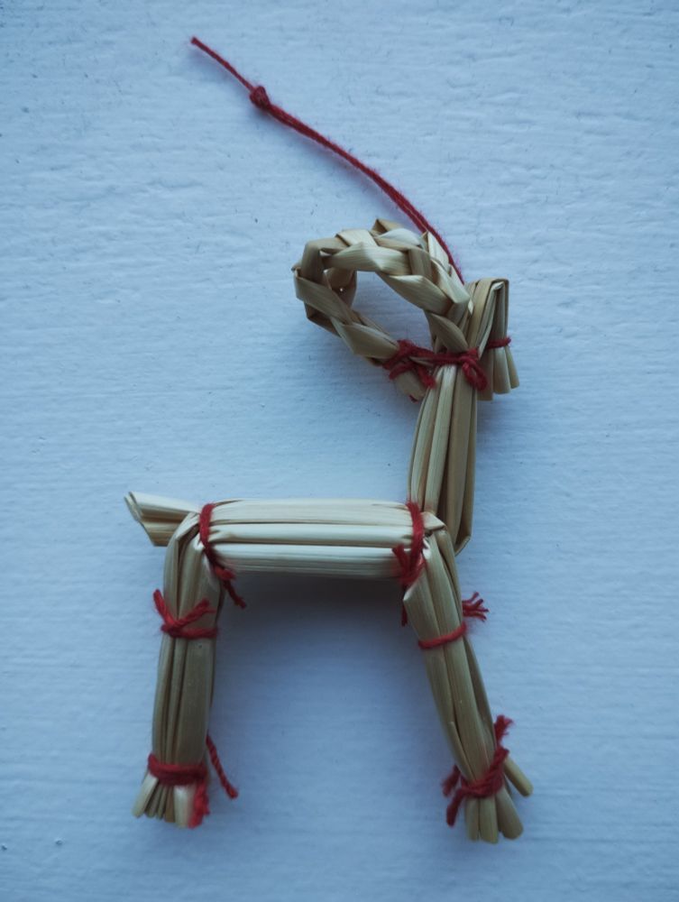 A goat ornament for a Christmas tree, crafted from straw