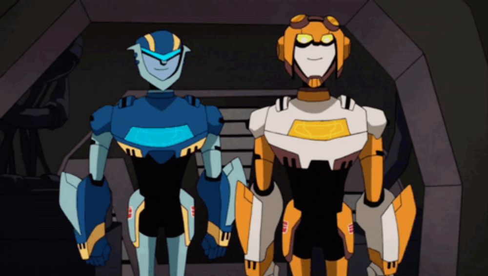 two cartoon robots are standing next to each other and one of them has the letters aa on it