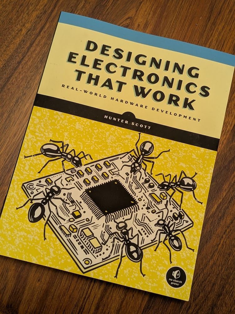 a physical copy of the book, "Designing Electronics That Work."
"Real-World Hardware Development"
by Hunter Scott
there's an illustration of a small square circuit board being attended by six ants.