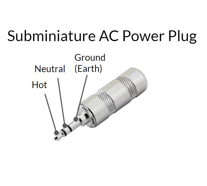 caption: Subminiature AC Power Plug. it's a 1/8" audio plug. The outer shell is marked Ground (Earth). The middle ring contact is Neutral, and the central pin is Hot.