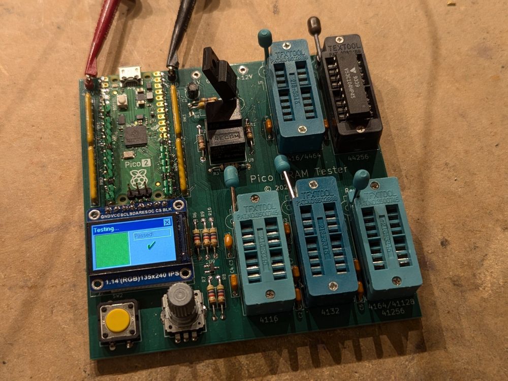 RAM tester circuit board with a nice high-res IPS LCD display, 5 sockets, and a Pico 2. the display has an old-school 3d shaded user interface