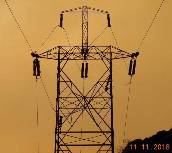 an electrical transmission tower with some insulators and wires. some insulators are not where they should be. the bottom right of the photo has the date "11.11.2018"