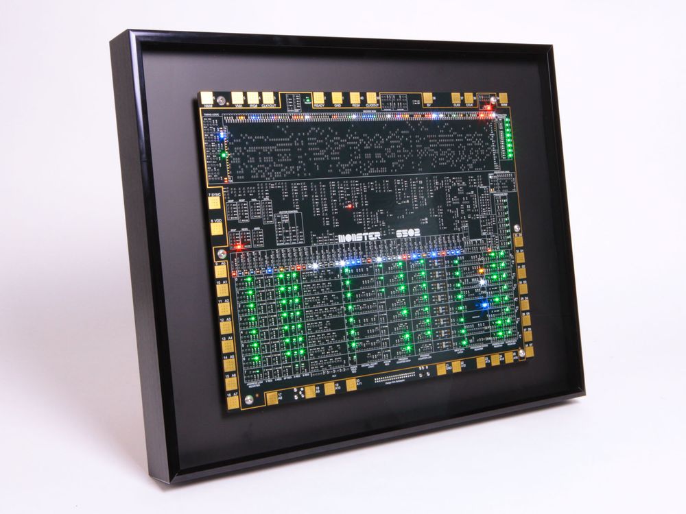 A large picture frame containing a circuit board, about 15 in x 12 in, completely covered with hundreds of LEDs and thousands of transistors!