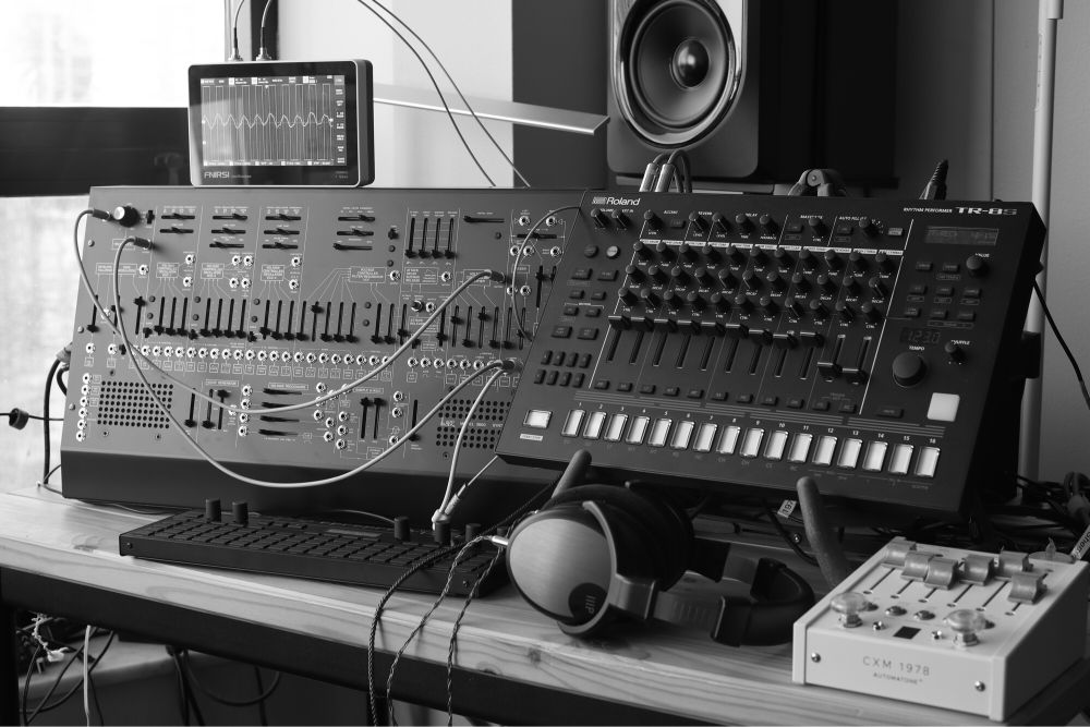 ARP 2600m with Roland TR-8s, SQ-64, and oscilloscope. Grayscale image.