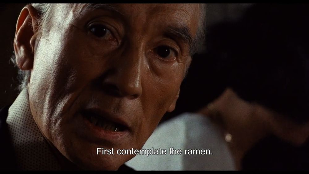 Screencap from Tampopo in which the ramen sensei instructs his young pupil to "contemplate the ramen."
