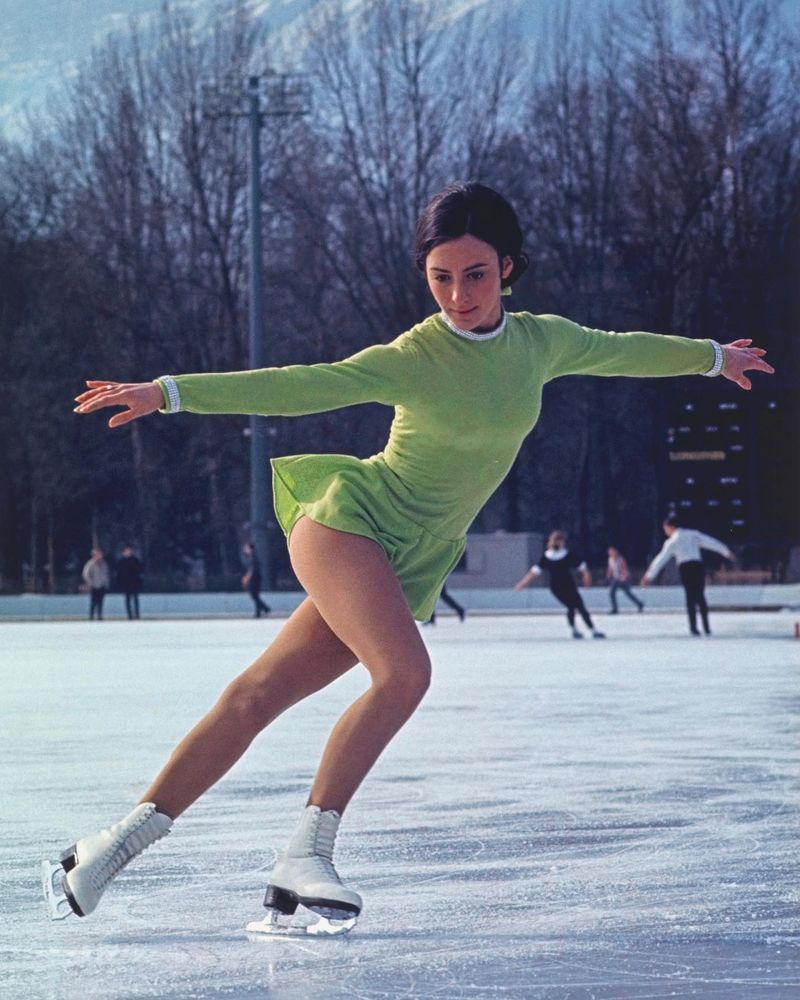 Peggy Fleming skating on an outdoor rink in her green costume while preparing for the 1968 Winter Olympics.