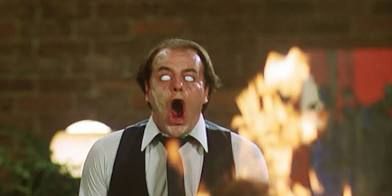 A man with white eyes and an open mouth looking absolutely horrified in David Cronenberg’s film “Scanners.”