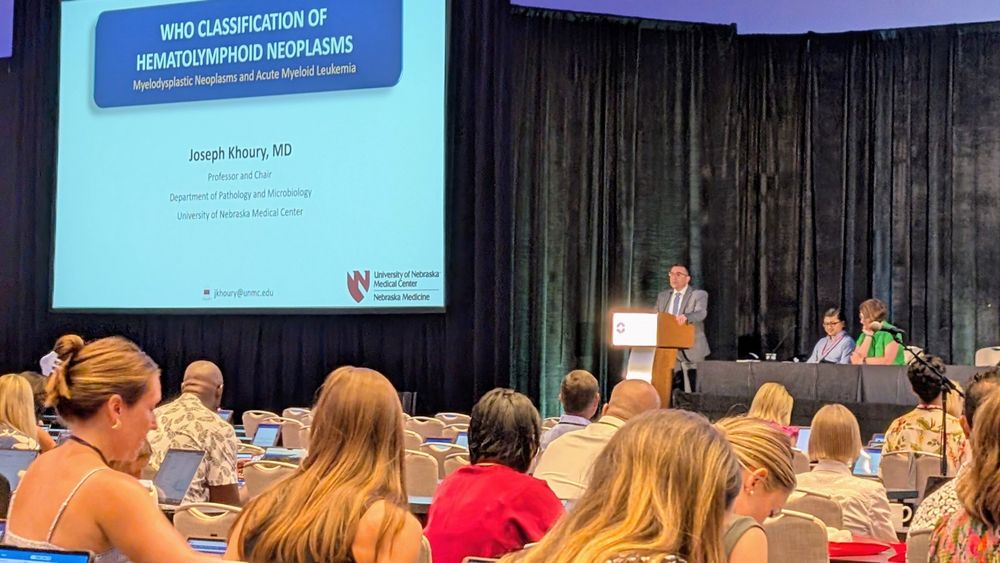 Dr. Joseph Khoury speaks to a roomful of people at the Pan Pacific Leukemia Conference in Maui.