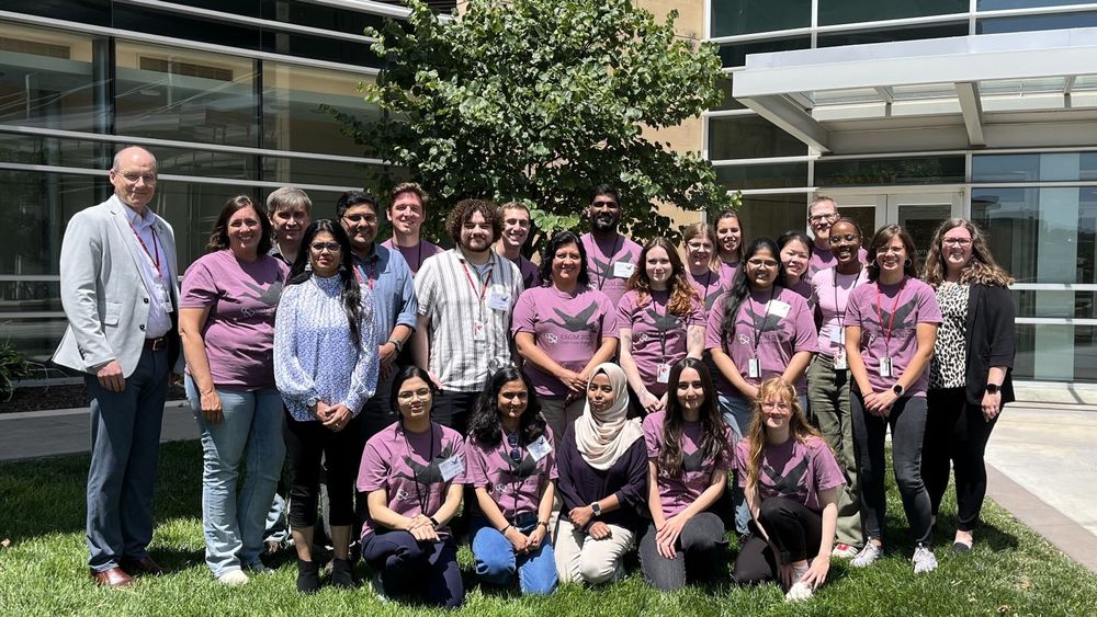 Group shot of UNMC staff with participants in the 2025 Staphylococcal Genetics and Metabolism workshop, outside Durham Research Center I on campus.