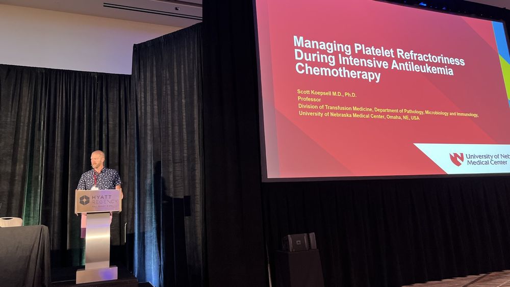 Dr. Scott Koepsell, professor in UNMC's Department of Pathology, Microbiology & Immunology, speaks at the podium at the Pan Pacific Leukemia Conference in Maui.