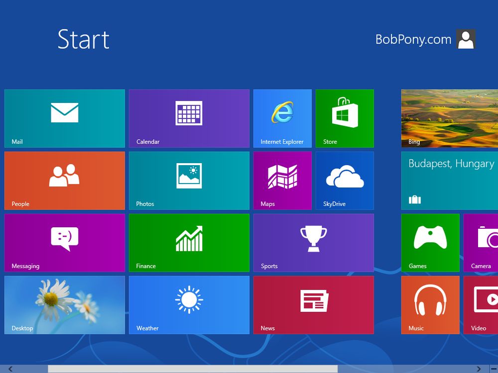Screenshot showing the full screen Start Screen in Windows 8 with bunch of preinstalled metro apps pinned as tiles.
