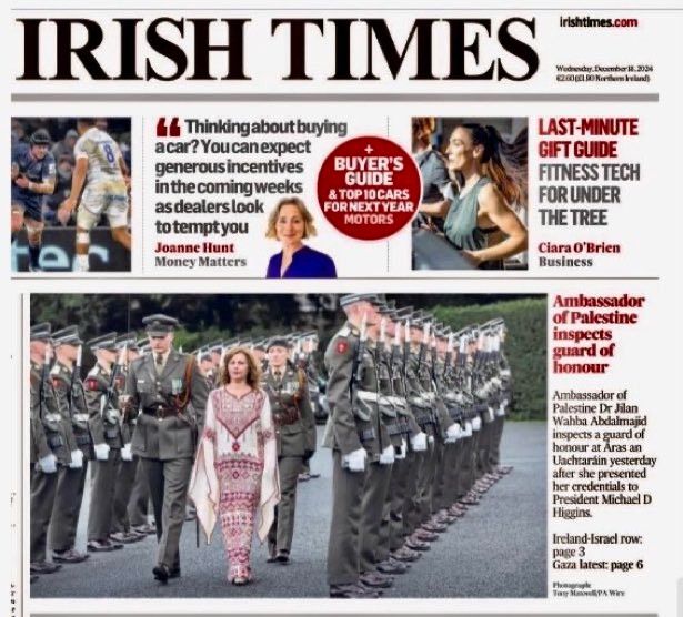 A screenshot of the front page of The Irish Times showing the Ambassador of Palestine in traditional Palestinian dress inspecting the guard of honour - rows of soldiers in formal uniform.