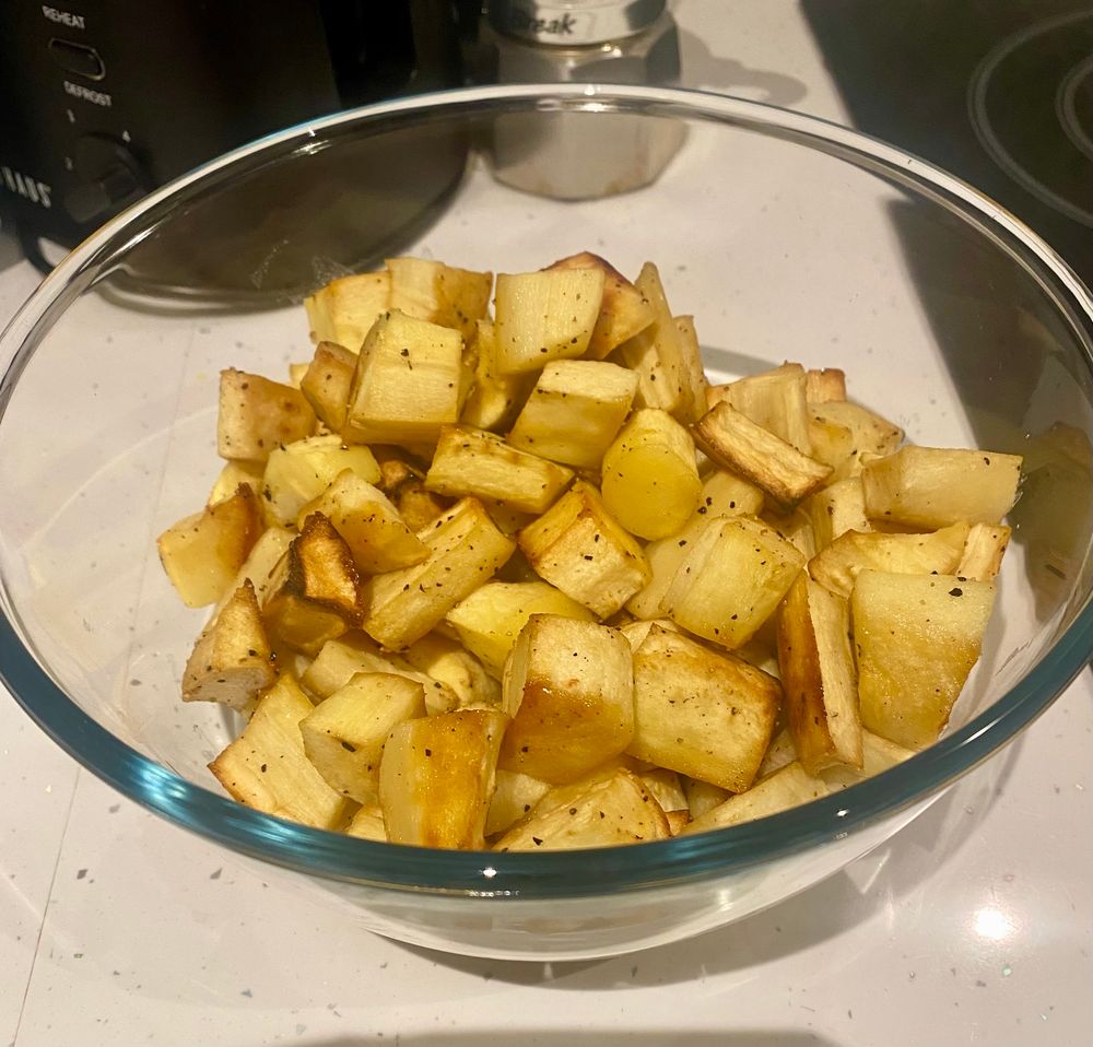 A bowl of roasted honeyed parsnip.