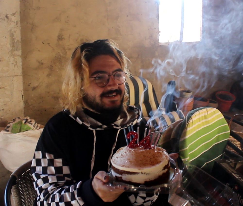A pic of me with a birthday cake in an old warehouse