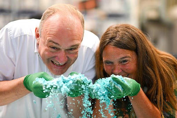 Ed Davey, Leader of the Liberal Democrats and Vikki Slade, Liberal Democrat MP for Mid Dorset and North Poole smell the ingredients as they learn to make bath bombs during a visit to the Lush factory, on July 18, 2025 in Poole, United Kingdom
